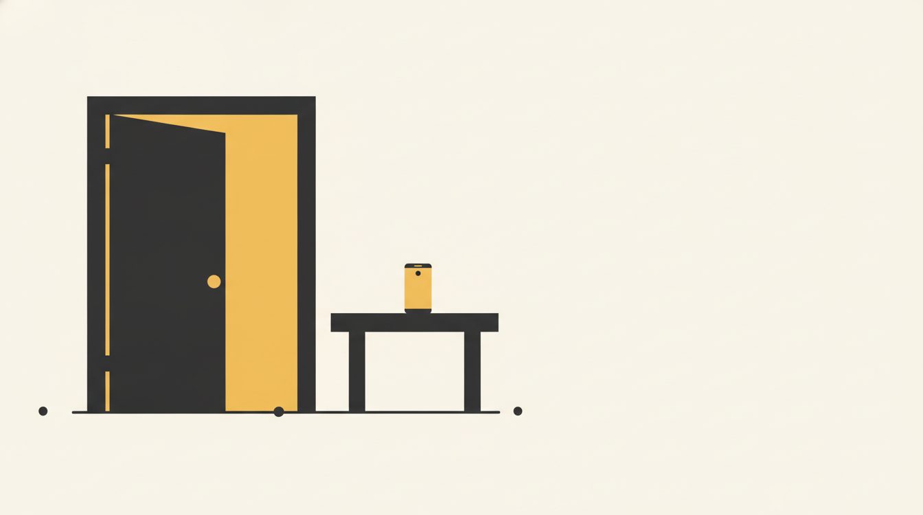 An open wooden door of a calm room with a small phone resting on a table inside