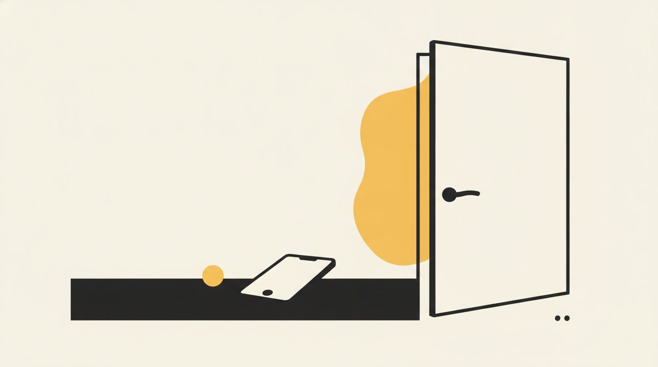 A phone lying face down on a table beside a half-open door with warm light coming through